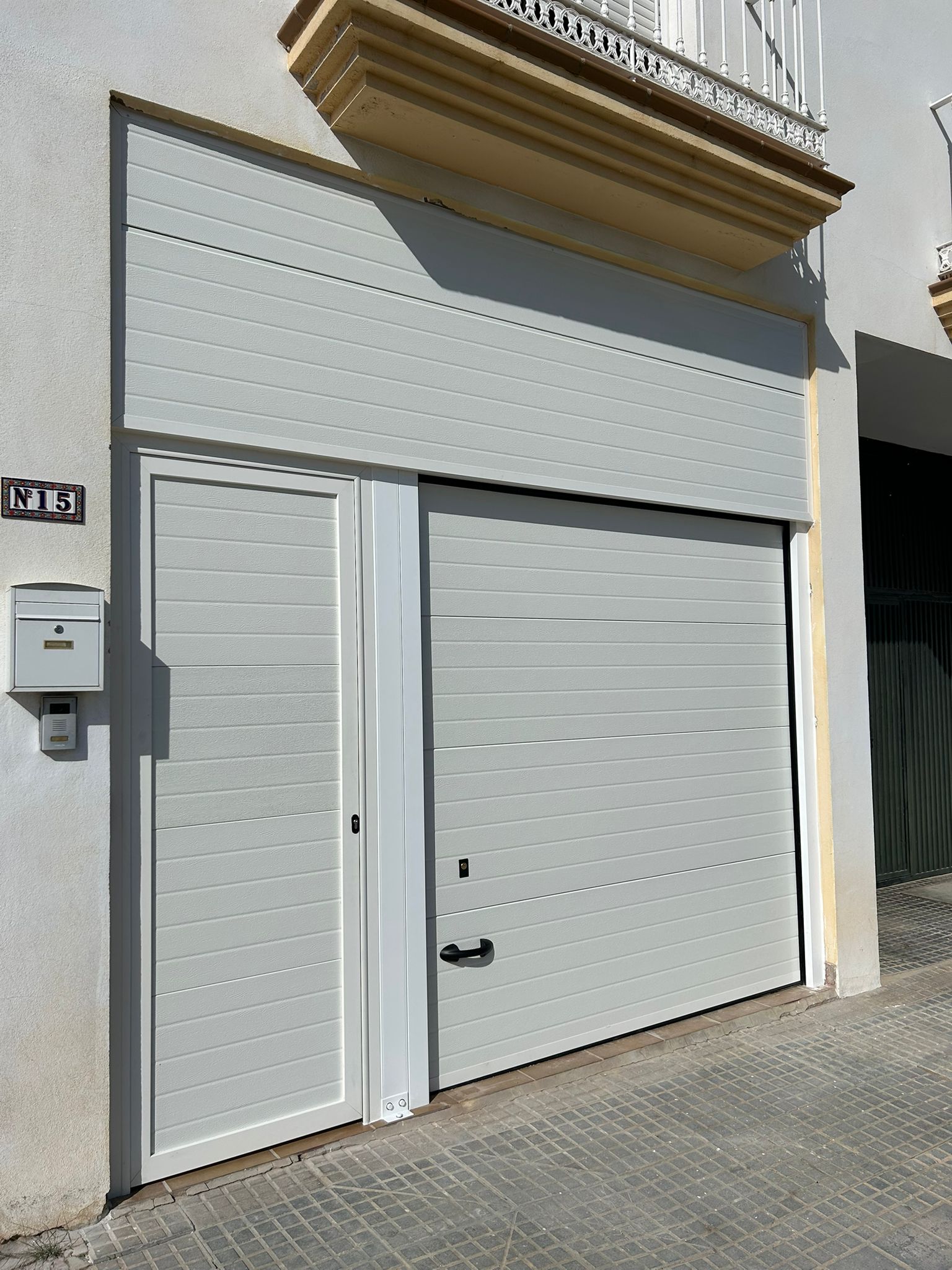 Puerta seccional y peatonal con fijo arriba acabado blanco